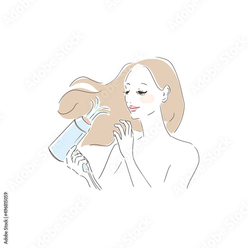 ヘアドライヤーで髪を乾かす美しい女性