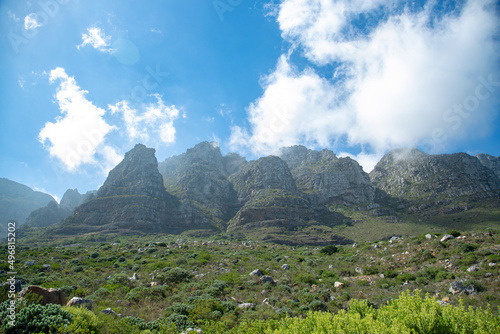 Bright blue sky with misty clouds over the Twelve Apostles mountain range in Cape Town, South Africa photo