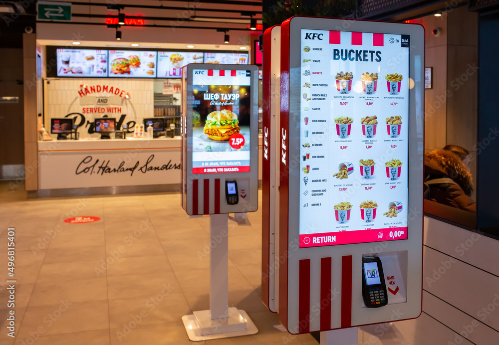 Self order kiosk machines installed inside of a KFC fast food