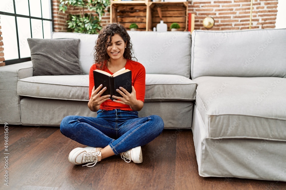 Young latin woman smiling confident reading bible at home Young latin woman smiling confident reading bible at home