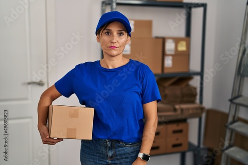 Middle age brunette woman working wearing delivery uniform and cap depressed and worry for distress, crying angry and afraid. sad expression.