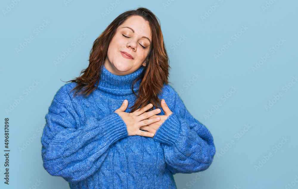 Young plus size woman wearing casual clothes smiling with hands on chest with closed eyes and grateful gesture on face. health concept. Young plus size woman wearing casual clothes smiling with hands on chest with closed eyes and grateful gesture on face. health concept.