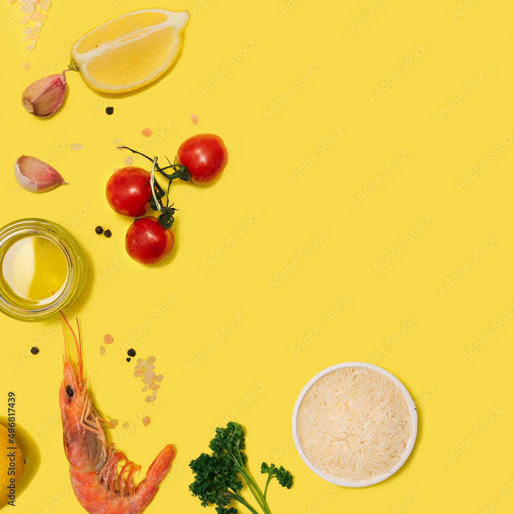Modern seafood minimal concept. Flat lay, made of fresh organic pink prawn, olive oil, rice, tomato, garlic, parsley, lemon, himalayan salt, pepper against yellow background. Creative copy space Modern seafood minimal concept. Flat lay, made of fresh organic pink prawn, olive oil, rice, tomato, garlic, parsley, lemon, himalayan salt, pepper against yellow background. Creative copy space