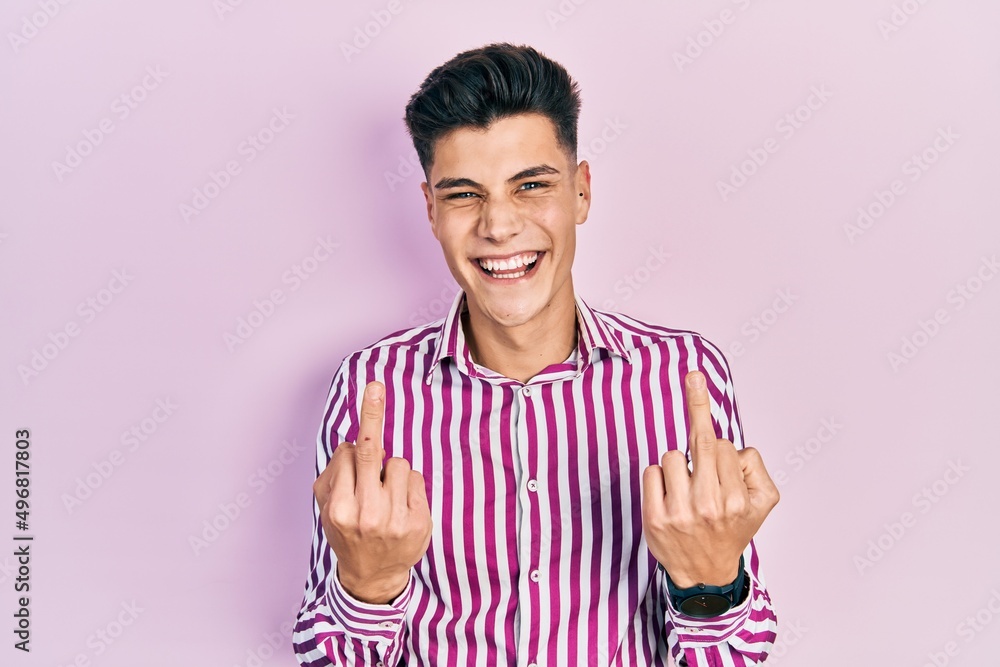 Obraz premium Young hispanic man wearing casual clothes showing middle finger doing fuck you bad expression, provocation and rude attitude. screaming excited