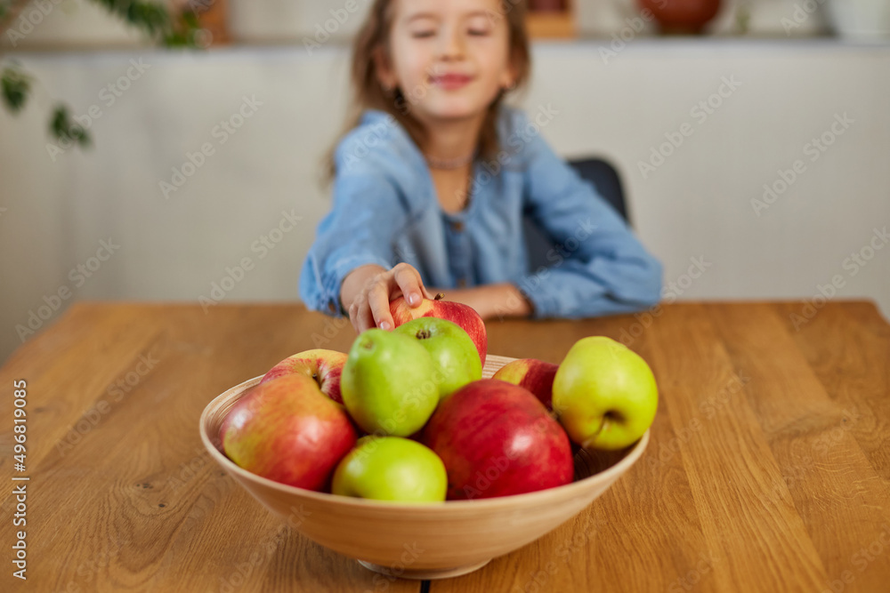 Little happy girl hold bowl with fruits in the kitchen at home, healthy child snack Little happy girl hold bowl with fruits in the kitchen at home, healthy child snack