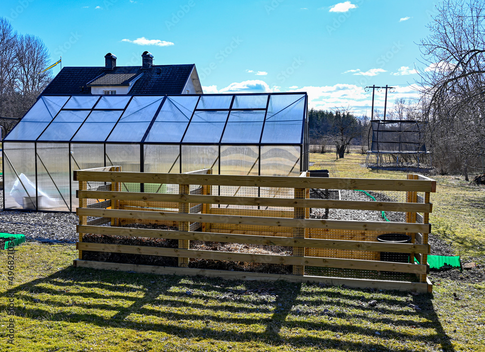 Compost greenhouse and house in springtime garden Stock Photo Adobe Stock