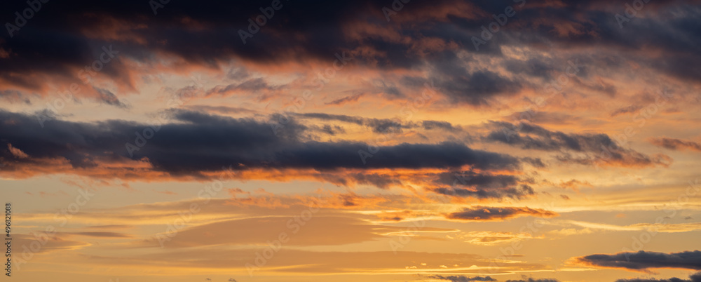 Sunset sky with orange clouds. Nature background.