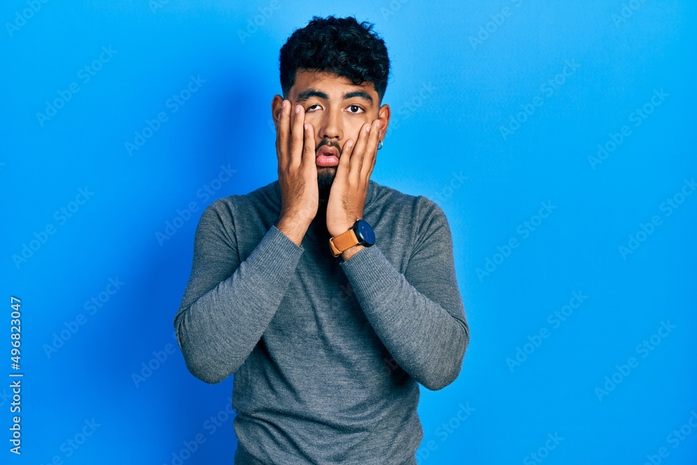 Arab man with beard wearing turtleneck sweater tired hands covering face, depression and sadness, upset and irritated for problem Arab man with beard wearing turtleneck sweater tired hands covering face, depression and sadness, upset and irritated for problem