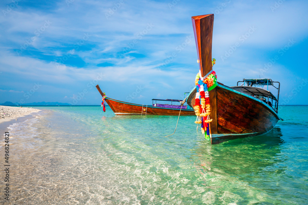 KRABI, THAILAND - Thai wooden motorboat, boat trips at sea, Clean white sand beaches, and emerald green sea.soft focus. KRABI, THAILAND - Thai wooden motorboat, boat trips at sea, Clean white sand beaches, and emerald green sea.soft focus.