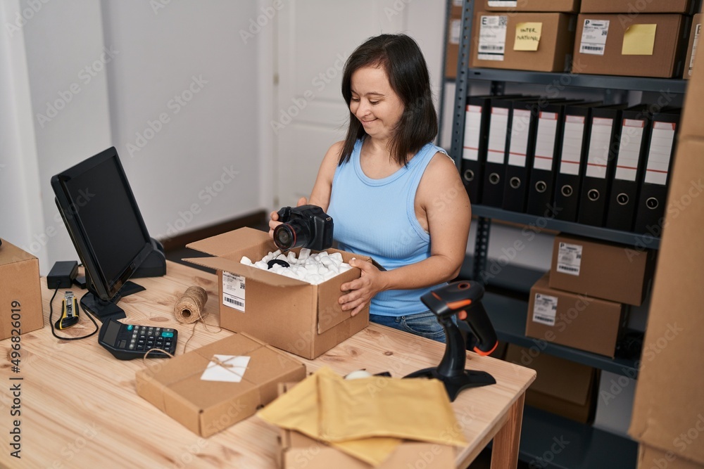 Down syndrome woman ecommerce business packing professional camera at office Down syndrome woman ecommerce business packing professional camera at office