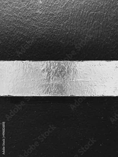 Silver stripe on black background with blur
