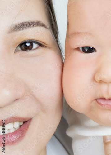 baby and mom asian closeup portrait  happy motherhood. mother and baby at home  selective focus