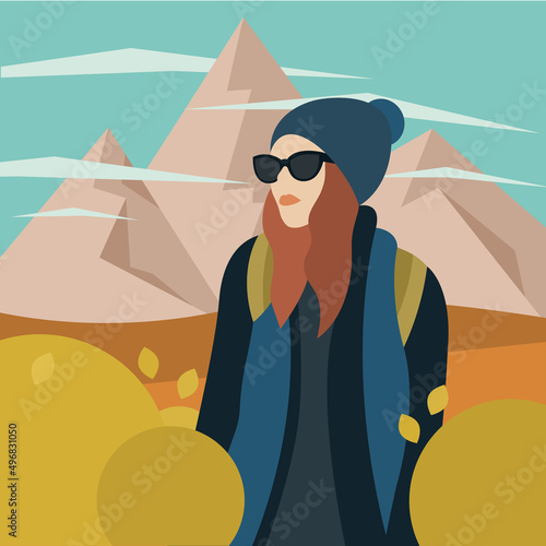 Chica con gorro y gafas de excursión en la montaña (ID: 496831050)