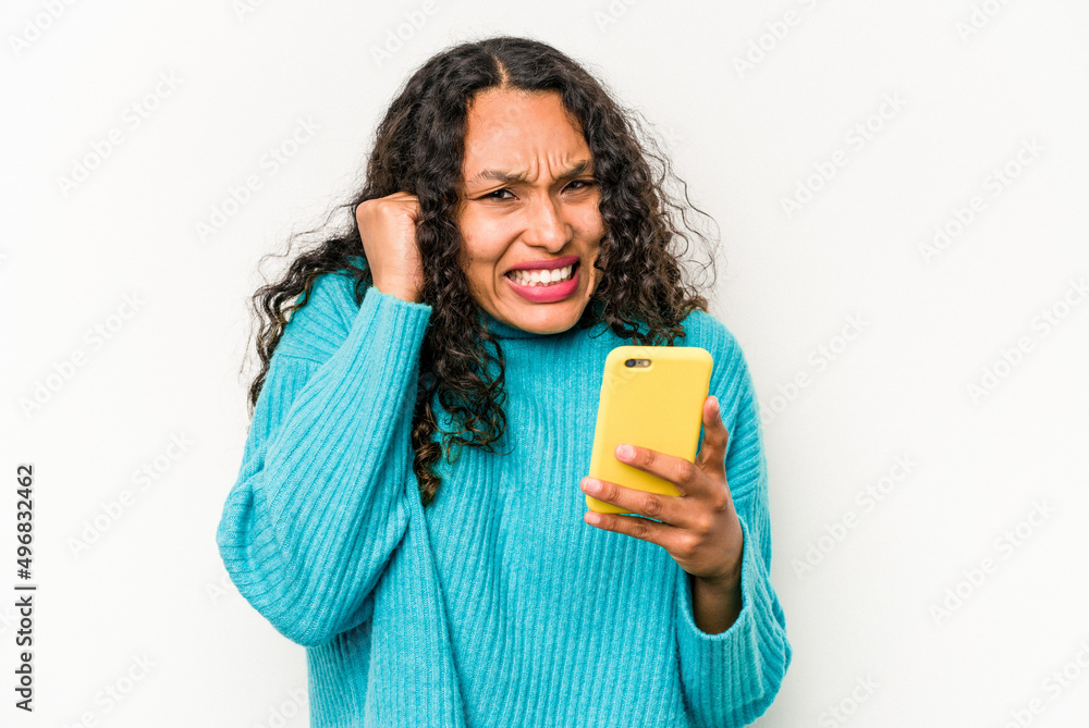 Young hispanic woman holding mobile phone isolated on white background covering ears with hands. Young hispanic woman holding mobile phone isolated on white background covering ears with hands.