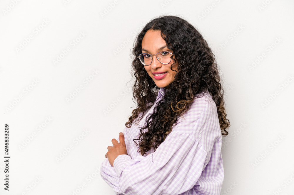 Young hispanic woman isolated on white background who feels confident, crossing arms with determination. Young hispanic woman isolated on white background who feels confident, crossing arms with determination.