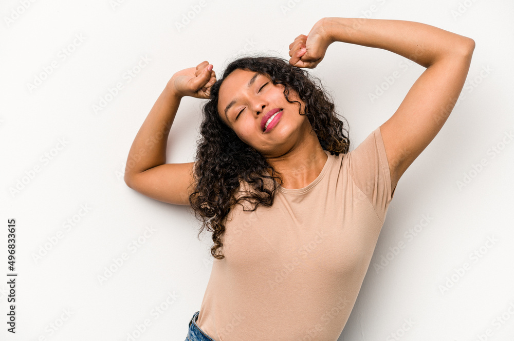 Young hispanic woman isolated on white background stretching arms, relaxed position.