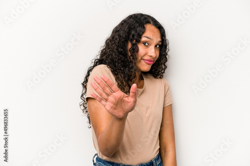 Young hispanic woman isolated on white background rejecting someone showing a gesture of disgust.