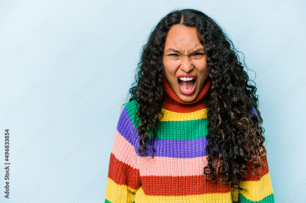 Young hispanic woman isolated on blue background shouting very angry, rage concept, frustrated. Young hispanic woman isolated on blue background shouting very angry, rage concept, frustrated.