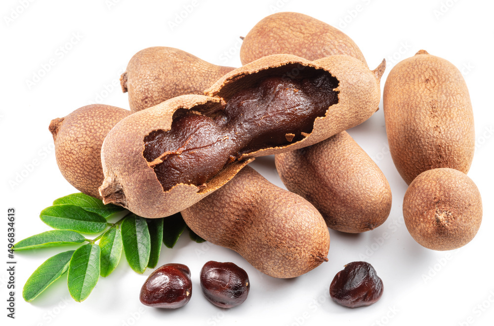 Fototapeta premium Ripe tamarind fruit, leaves and some tamarind seeds isolated on white background.