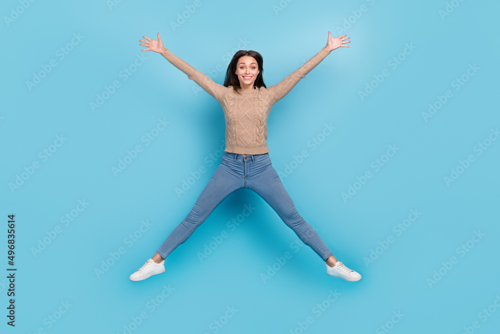 Full length body size view of attractive cheerful girl jumping having fun isolated over bright blue color background
