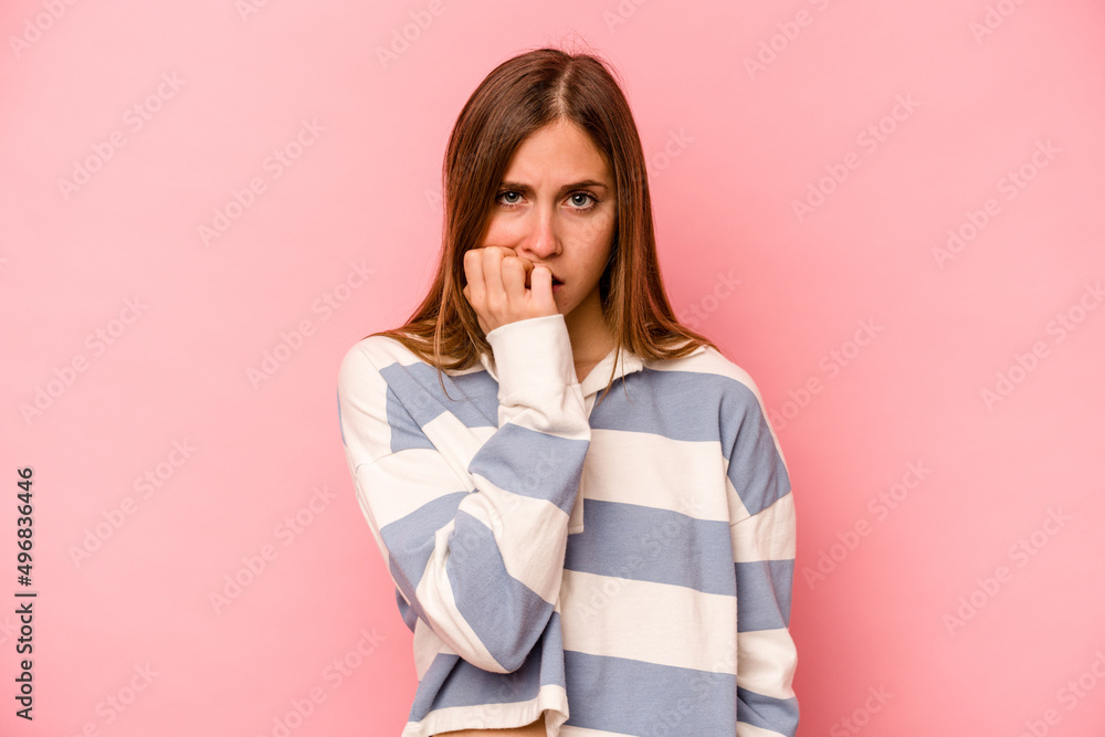 Young caucasian woman isolated on pink background biting fingernails, nervous and very anxious. Young caucasian woman isolated on pink background biting fingernails, nervous and very anxious.