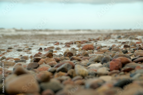 stones lie beautifully on the seashore. stones on the sand.