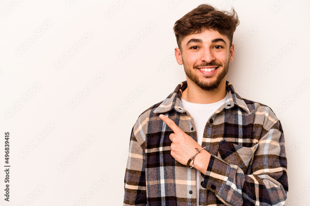 Young hispanic man isolated on white background smiling and pointing aside, showing something at blank space. Young hispanic man isolated on white background smiling and pointing aside, showing something at blank space.