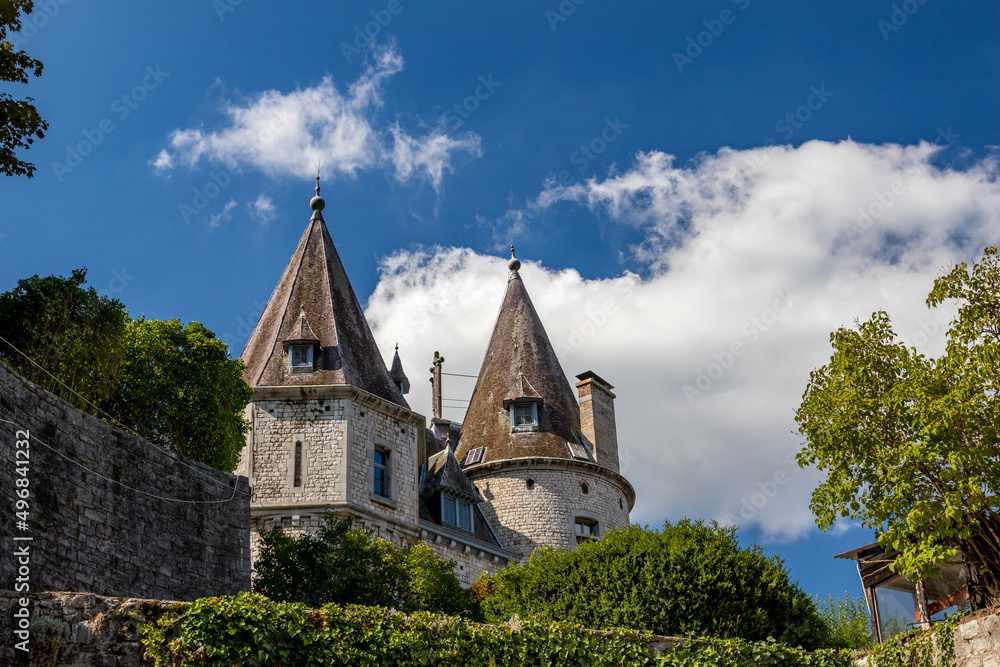 Belgium, country-side view with the top part of a castle with round towers Belgium, country-side view with the top part of a castle with round towers