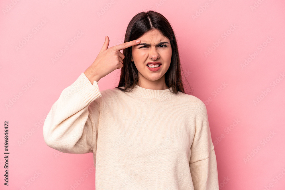 Young caucasian woman isolated on pink background showing a disappointment gesture with forefinger. Young caucasian woman isolated on pink background showing a disappointment gesture with forefinger.