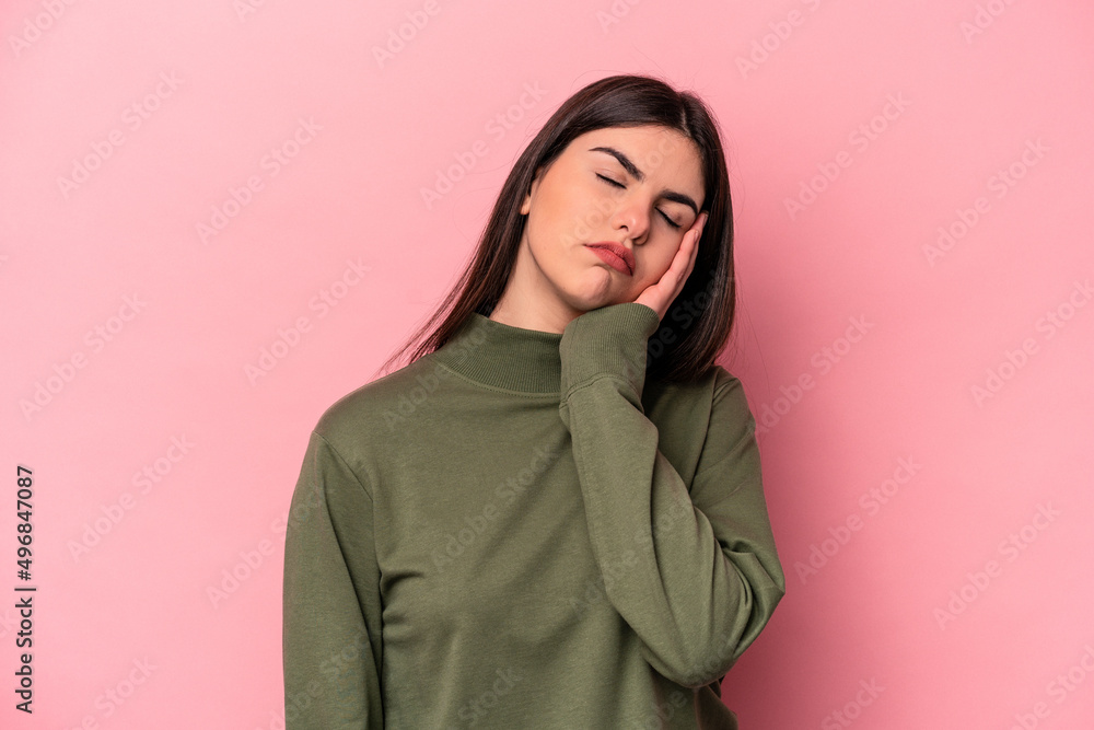 Young caucasian woman isolated on pink background who is bored, fatigued and need a relax day. Young caucasian woman isolated on pink background who is bored, fatigued and need a relax day.