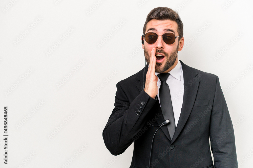 Young caucasian bodyguard man isolated on white background is saying a secret hot braking news and looking aside Young caucasian bodyguard man isolated on white background is saying a secret hot braking news and looking aside
