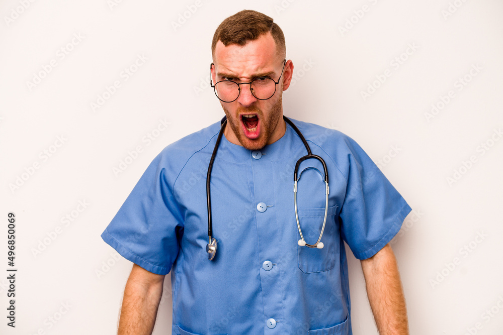 Young caucasian nurse man isolated on white background screaming very angry and aggressive. Young caucasian nurse man isolated on white background screaming very angry and aggressive.