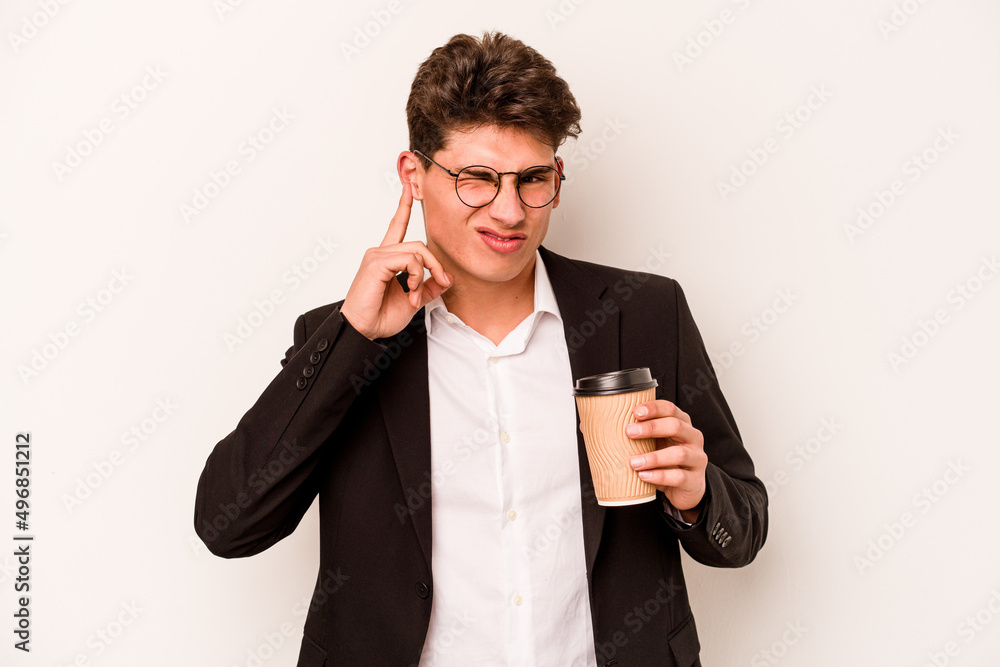 Young caucasian business man holding takeaway coffee isolated on white background covering ears with hands. Young caucasian business man holding takeaway coffee isolated on white background covering ears with hands.