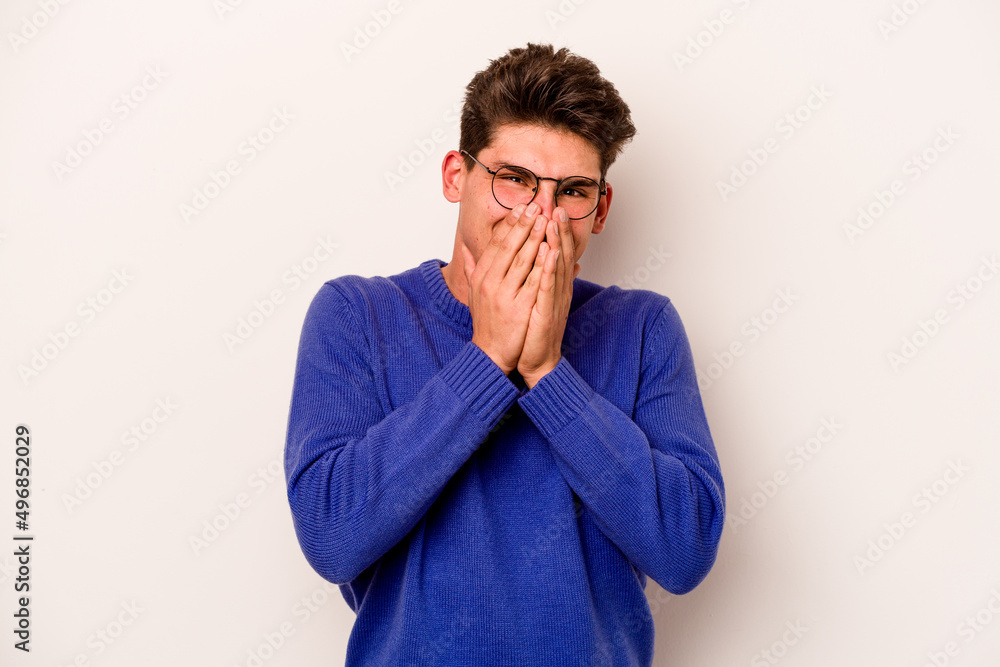 Young caucasian man isolated on white background laughing about something, covering mouth with hands. Young caucasian man isolated on white background laughing about something, covering mouth with hands.