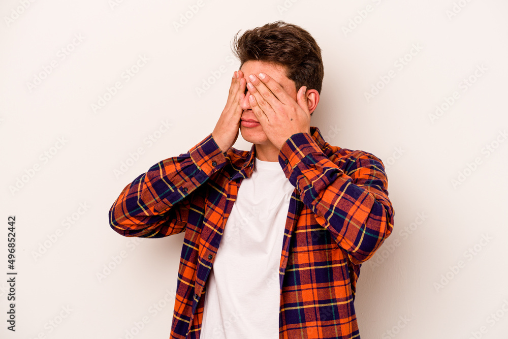 Young caucasian man isolated on white background afraid covering eyes with hands. Young caucasian man isolated on white background afraid covering eyes with hands.