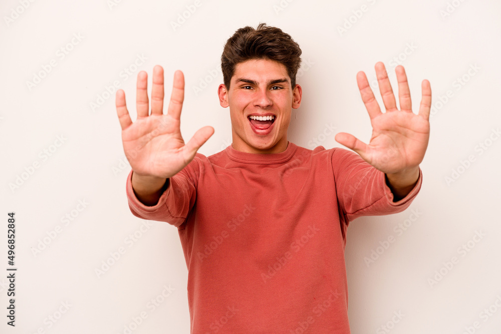 Young caucasian man isolated on white background showing number ten with hands. Young caucasian man isolated on white background showing number ten with hands.