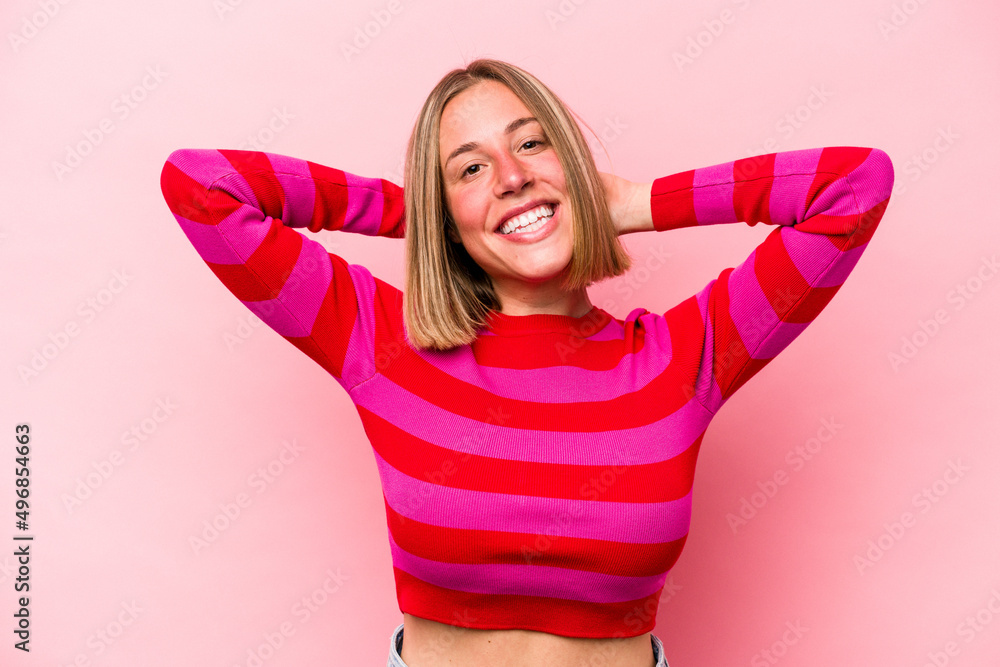 Young caucasian woman isolated on pink background stretching arms, relaxed position. Young caucasian woman isolated on pink background stretching arms, relaxed position.