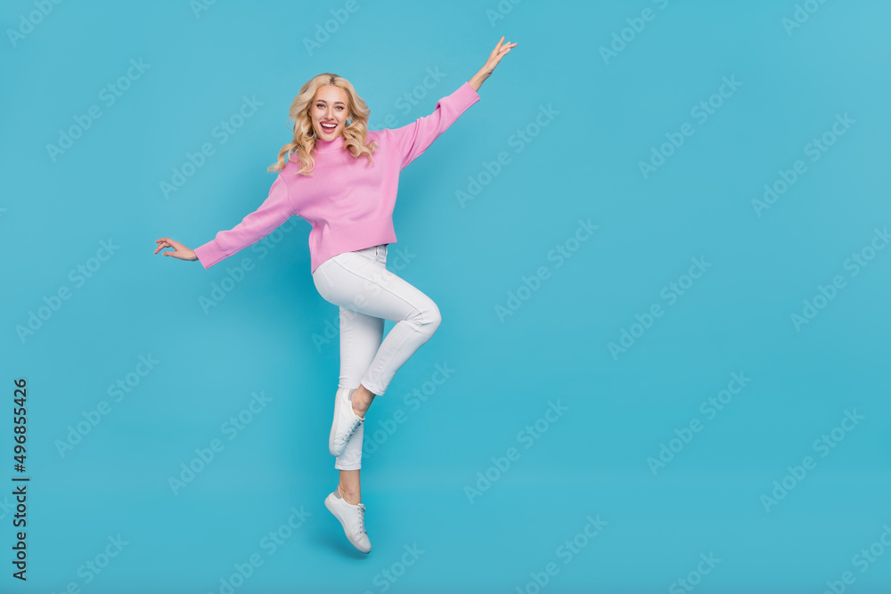 Full length body size view of attractive cheerful wavy-haired girl dancing jumping isolated over bright blue color background Full length body size view of attractive cheerful wavy-haired girl dancing jumping isolated over bright blue color background
