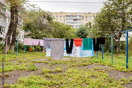 Laundry dries on the rope in courtyard of Khrushchyovka. Khrushchyovka is common type of old low-cost apartment building in Russia and post-Soviet space. Household concept. Russia, Vladivostok.