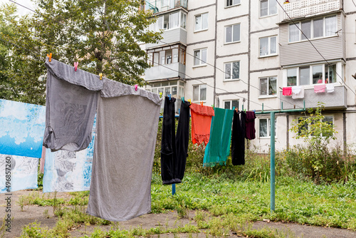 Laundry dries on the rope in courtyard of Khrushchyovka. Khrushchyovka is common type of old low-cost apartment building in Russia and post-Soviet space. Household concept. Russia, Vladivostok.