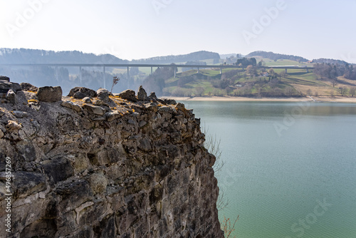 Bridge over the lake of Gruyere in Ogoz Island surrounded by the mountains photo