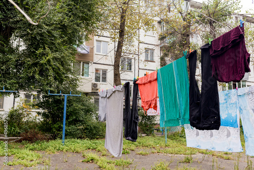 Laundry dries on the rope in courtyard of Khrushchyovka. Khrushchyovka is common type of old low-cost apartment building in Russia and post-Soviet space. Household concept. Russia, Vladivostok. photo