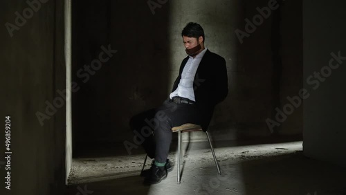 The male hostage was caught in a chair by the assailant, tape over his mouth, rope tied to his feet and hands, trying to resist to release of the rope. in prison