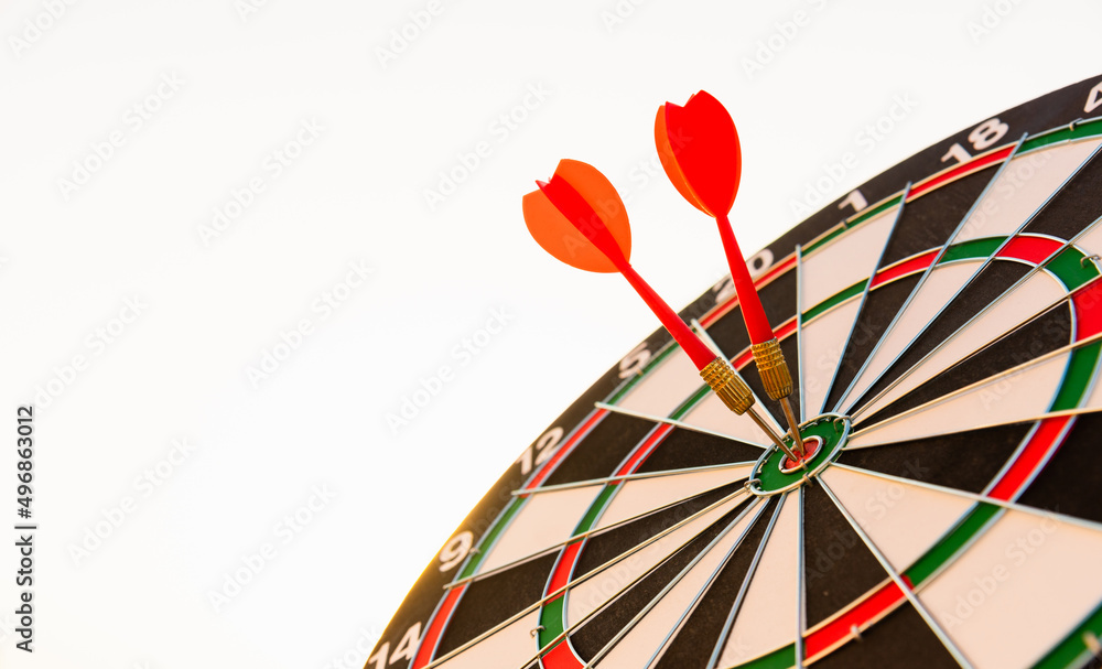 Closeup the dart arrow hit center on Bullseye(bull's-eye) of a dartboard is a target of challenge business, strategy marketing target, objective financial and goal a concept Closeup the dart arrow hit center on Bullseye(bull's-eye) of a dartboard is a target of challenge business, strategy marketing target, objective financial and goal a concept