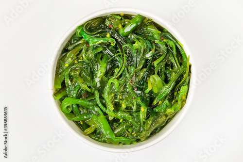 A bowl of pickled chukka. White background. Top view.