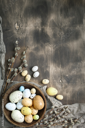 Congratulatory easter background. Easter eggs and flowers. Selective focus. Top view. Background with copy space.