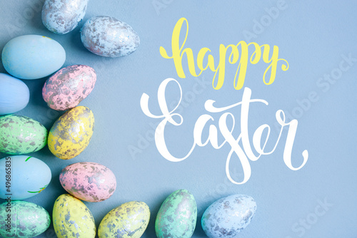 Congratulatory easter background. Easter eggs and flowers. Selective focus. Top view.