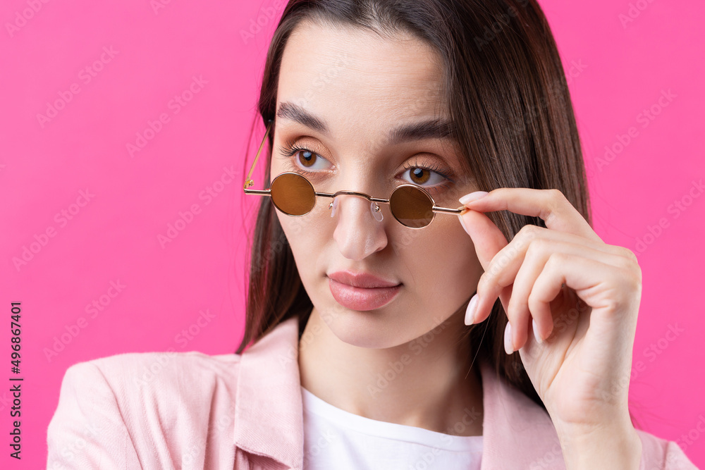Portrait of beautiful young woman in pink jacket thinking isolated on red background Portrait of beautiful young woman in pink jacket thinking isolated on red background