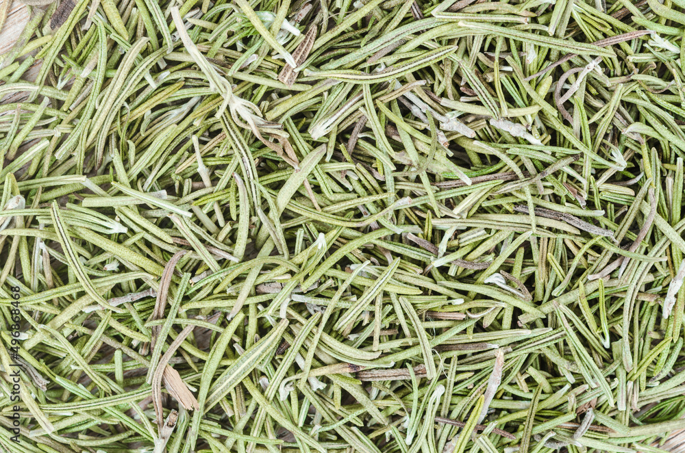 Dried rosemary condiment background solid. Dried rosemary condiment background solid.