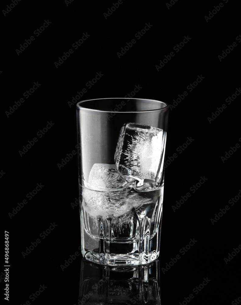 Glass with ice and water on black background Glass with ice and water on black background